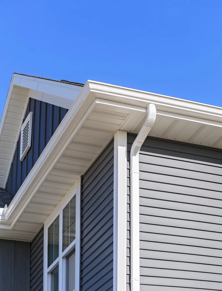 american house with new gutter system right after gutter installation service
