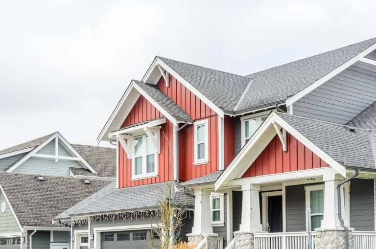 new red siding and asphalt roof installation